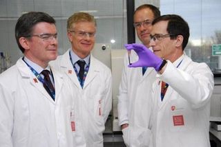 British Sports Minister Hugh Robertson (L), London 2012 Chief Executive Paul Deighton (2L), and British businessman CEO of GlaxoSmithKline (GSK) Andrew Witty (2R), are shown a vial of blood by British professor David Cowan (R), the head of Science for London 2012 and director of King's College London's Drug Control Centre