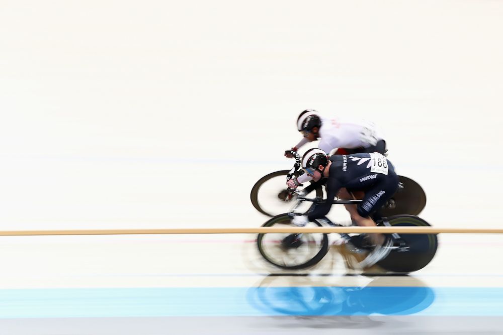 Jack Carlin of Great Britain and Zac Williams (black) of New Zealand compete in the Men's Sprint 1/16 Finals