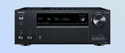 Hero review image on blue background showing front panel of Onkyo TX-NR7100 AV receiver