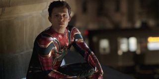 Spider-Man: Far From Home Peter sits on a roof in a somber mood, wearing his Iron Spider uniform