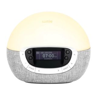 A Lumie sunrise alarm clock with a grey base on a white background.