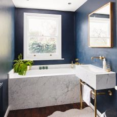 small bathroom colour ideas: blue walls and marble bath and sink