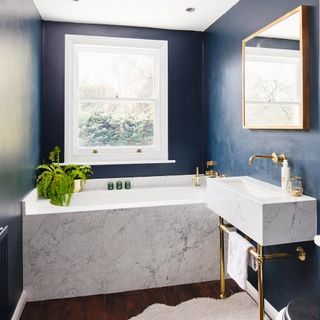 blue bathroom with marble bath and sink