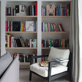 white book shelves and white chair
