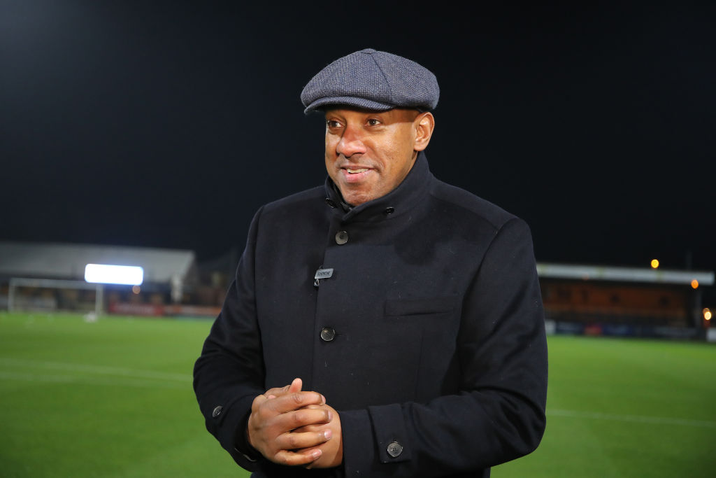 Former Cambridge United player and newly elected member to the board of directors Dion Dublin looks on prior to the Emirates FA Cup First Round Replay between Cambridge United and Northampton Town at Abbey Stadium on November 16, 2021 in Cambridge, England.