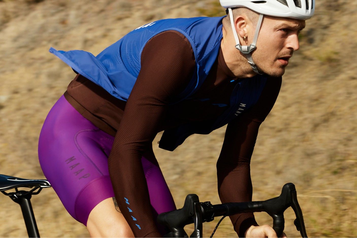 A man riding a bike in MAAP 2023 road collection kit