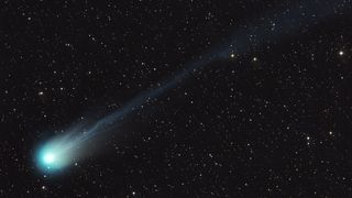 A green-tinged comet as seen in the night sky