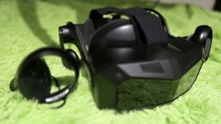 A Pimax Crystal Super virtual reality headset on a green background.