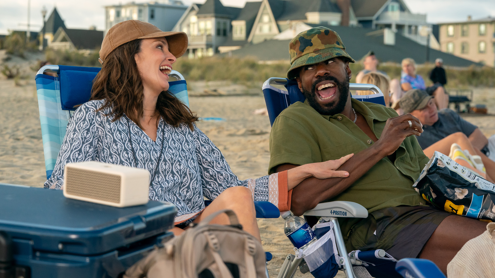 Tina Fey as Kate and Colman Domingo as Danny, laughing while sitting on the beach, in Episode 203 of The Four Seasons, Season 2.