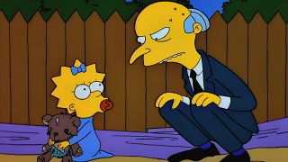 Mr Burns crouching down in front of Maggie and his bear, Rosebud