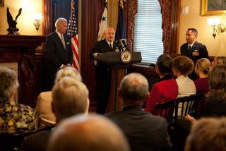 Captain Mark Kelly speaks at his retirement ceremony with Vice President Joe Biden in the Secretary of War Suite in the Eisenhower Executive Office Building, in Washington, D.C., Oct. 6, 2011.