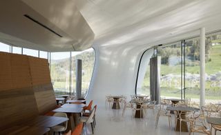 The curved concrete structure with a view of the landscaped gardens