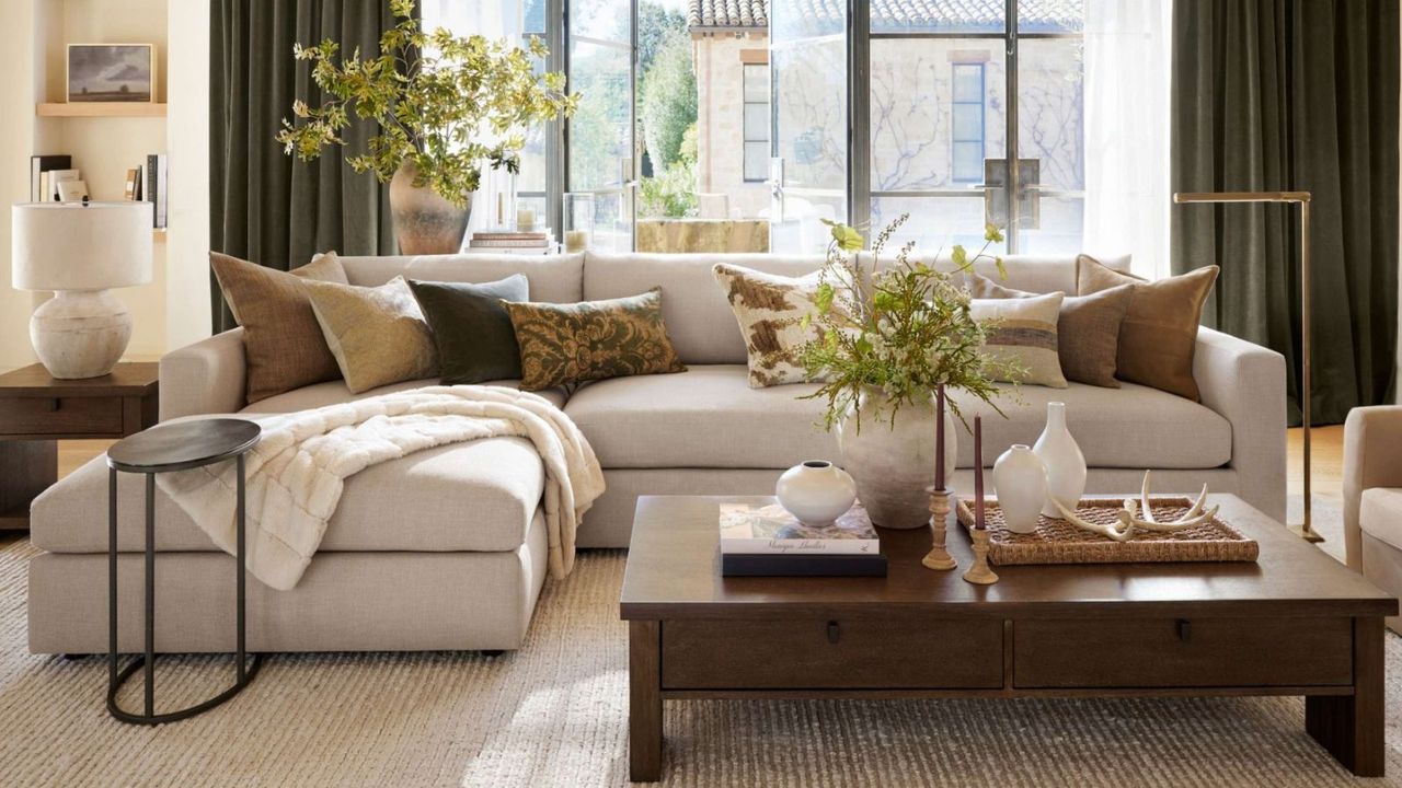 Cozy living room with large cream sectional and wooden coffee table