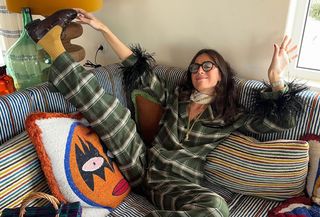 woman in pajamas on a colorful sofa