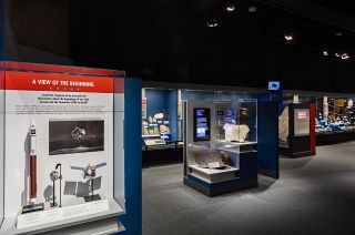 The OSIRIS-REx Bennu sample display case (at far left) now on view in the Janet Annenberg Hooker Hall of Geology, Gems, and Minerals meteorite gallery at the Smithsonian's National Museum of Natural History in Washington, D.C.