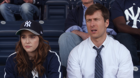 Zoey Deutch And Glen Powell at a baseball game in Set It Up 