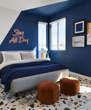 A dark blue and white bedroom designed by Bobby Berk