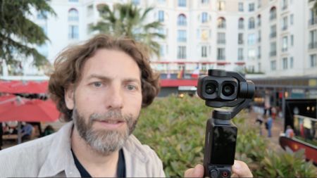 Adam Juniper holding the DJI Osmo Pocket 4P at the Cannes Film Festival
