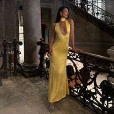 Woman wearing yellow satin dress.