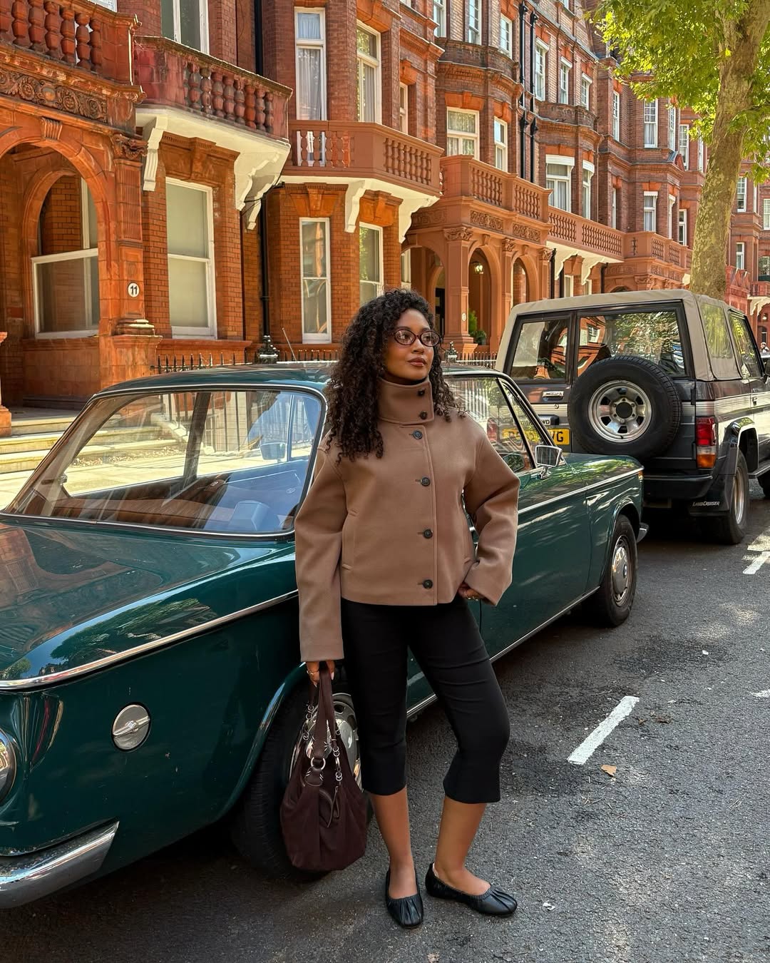Influencer Layla Abbey wearing black trousers with black shoes.