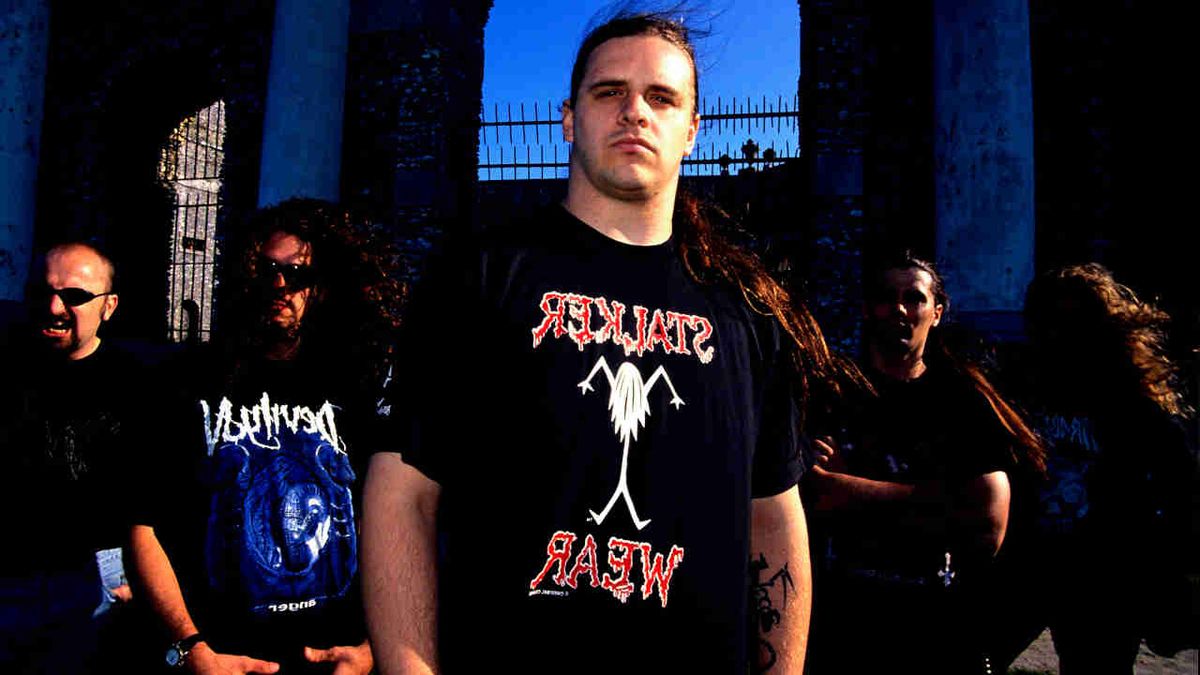 Cannibal Corpse posing for a photograph in a graveyard