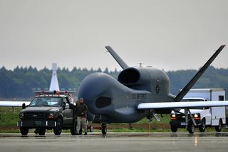 An RQ-4 Global Hawk from Andersen Air Force Base is towed down the runway at Misawa AB