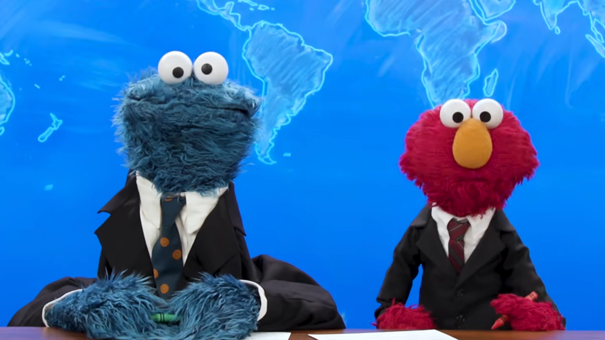 Cookie Monster and Elmo doing Weekend Update.