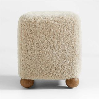 Cream shearling footstool with wooden ball legs