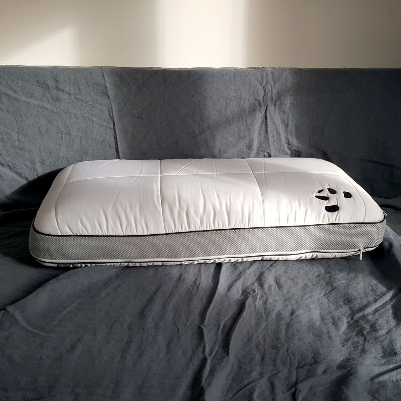The Panda Hybrid Bamboo pillow with grey mesh edge and zip around the edge on grey bedding