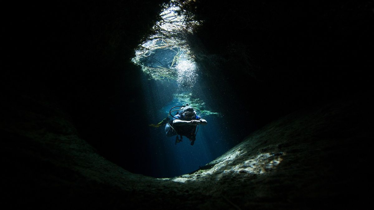 Scuba diver exploring underwater cave