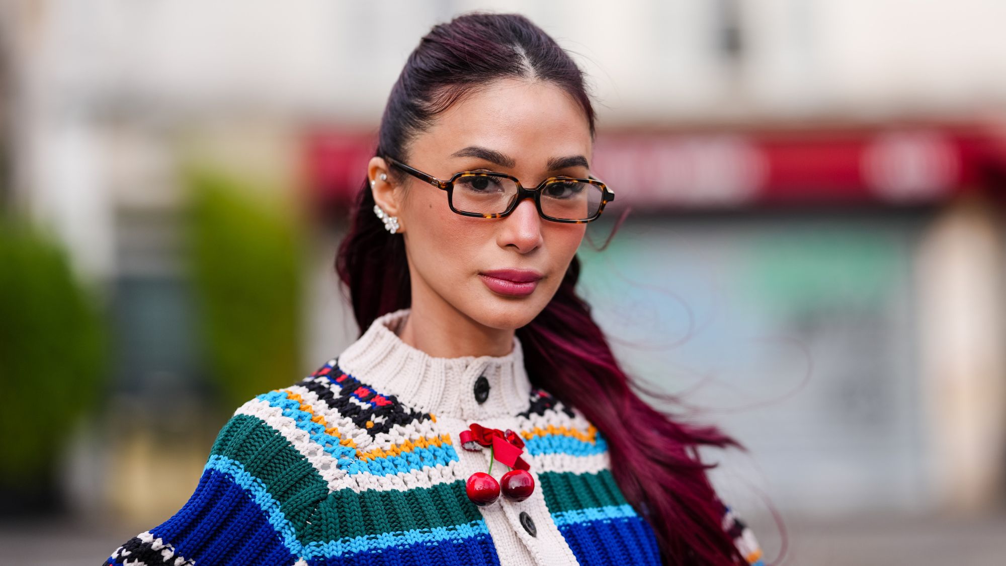 street style image of woman with deep burgundy hair
