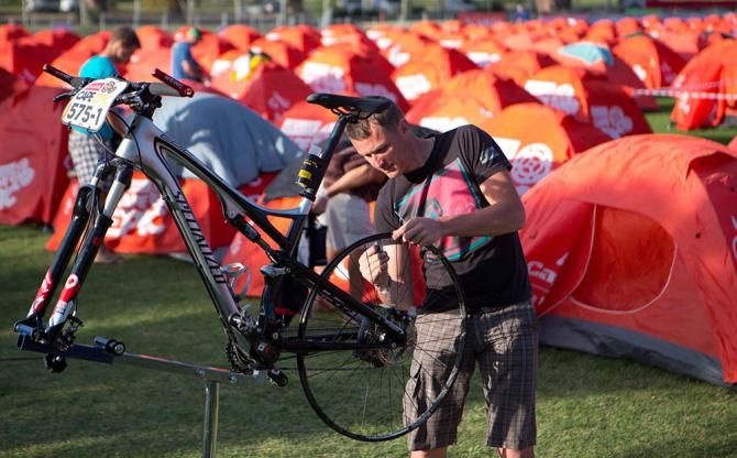 A bike mechanic works on a bike