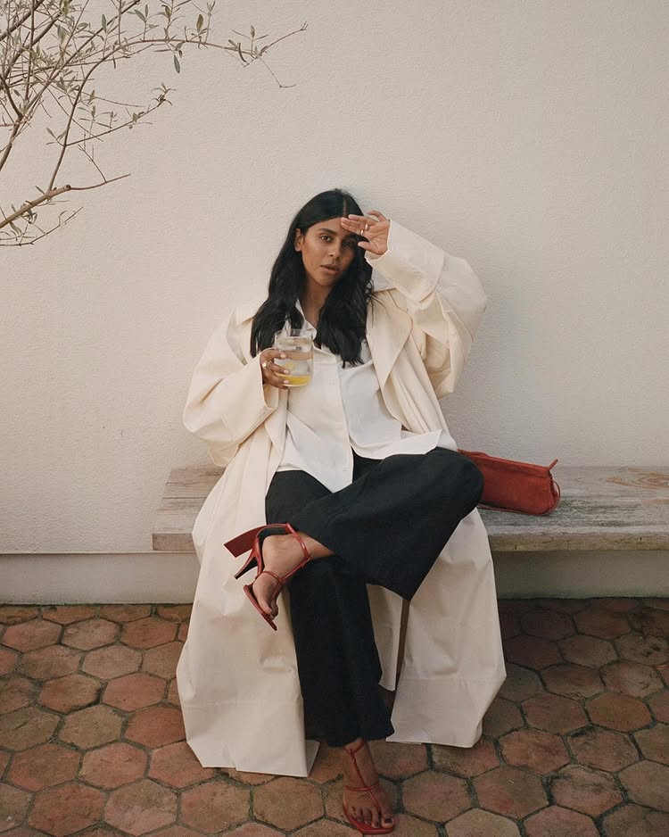 An image of @monikh wearing a white shirt with black trousers and red heels.