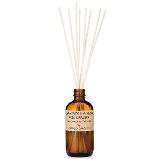 Oakmoss & Amber Reed Diffuser Set showing an amber glass diffuser bottle with multiple white reeds sticking out of the top