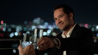 Manuel Garcia-Rulfo as Mickey Haller making a toast in The Lincoln Lawyer season 2 episode 7
