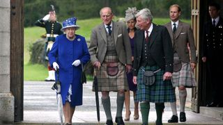 Queen Elizabeth II, Prince Philip, Duke of Edinburgh, Sophie, Countess of Wessex, and Prince Edward, Earl of Wessex, walk together during a garden party at Balmoral Castle