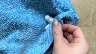 Using a cloth to clean the apple airpods pro