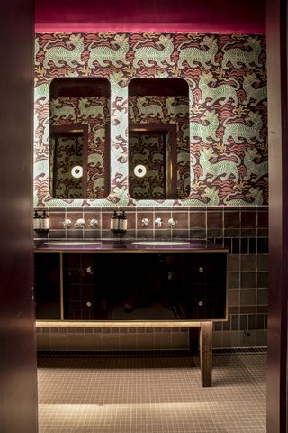 powder room with animal wallpaper, mirrors, purple vanity unit, wall tiles and floor tiles