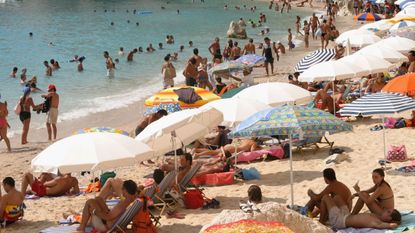 Tourists visit a Greek beach