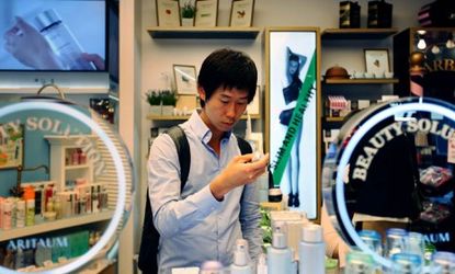 A 24-year-old South Korean college student shops for skincare and makeup products at a cosmetics store in Seoul.