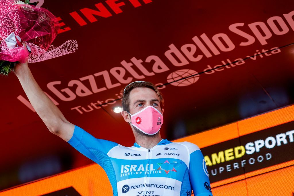 Team Israel StartUp Nation rider Englands Alex Dowsett wearing a face mask celebrates on the podium after winning the 8th stage of the Giro dItalia 2020 cycling race a 200kilometer route between Giovinazzo and Vieste on October 10 2020 Photo by Luca Bettini AFP Photo by LUCA BETTINIAFP via Getty Images