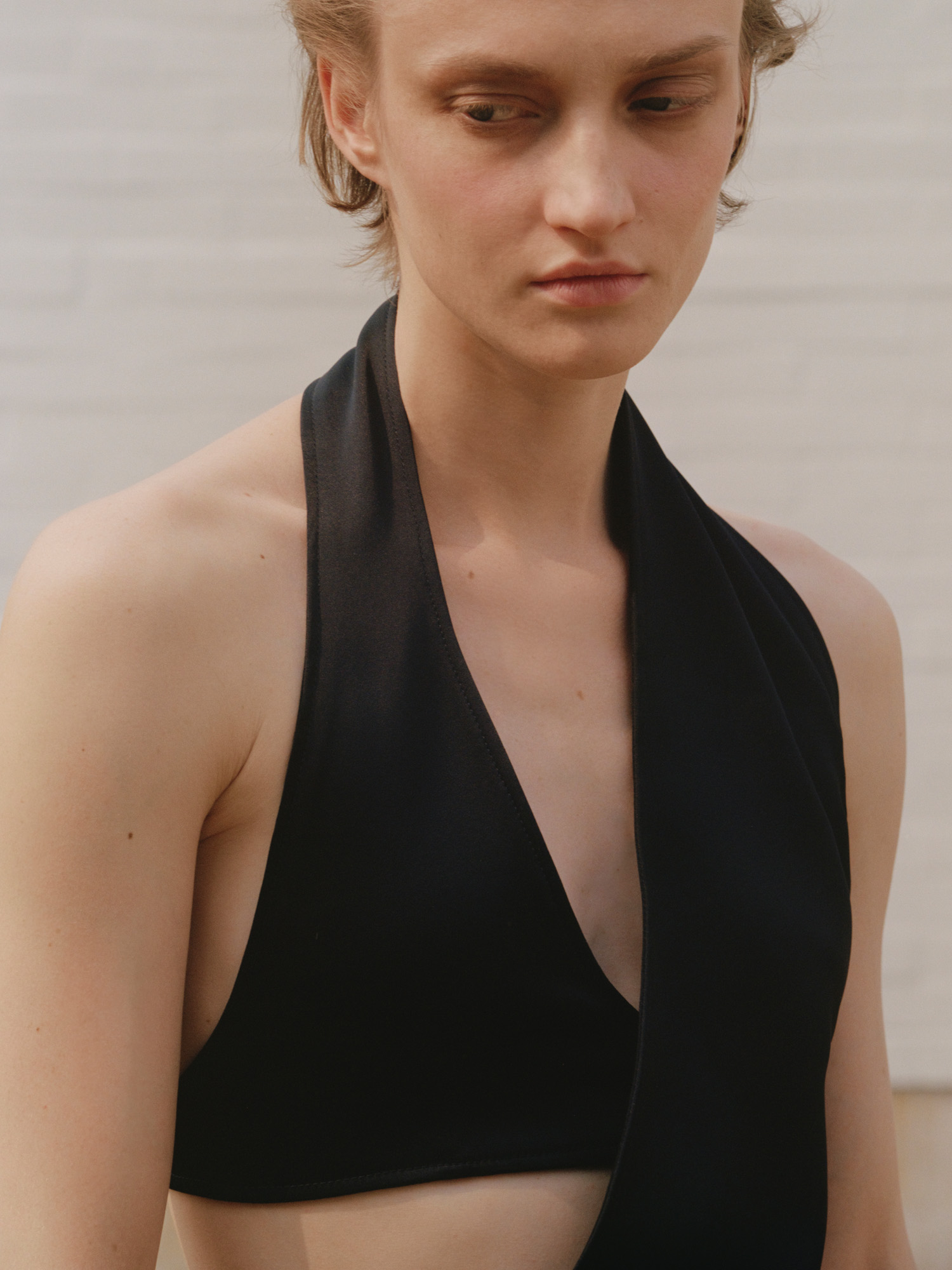 Model wears black cutaway dress