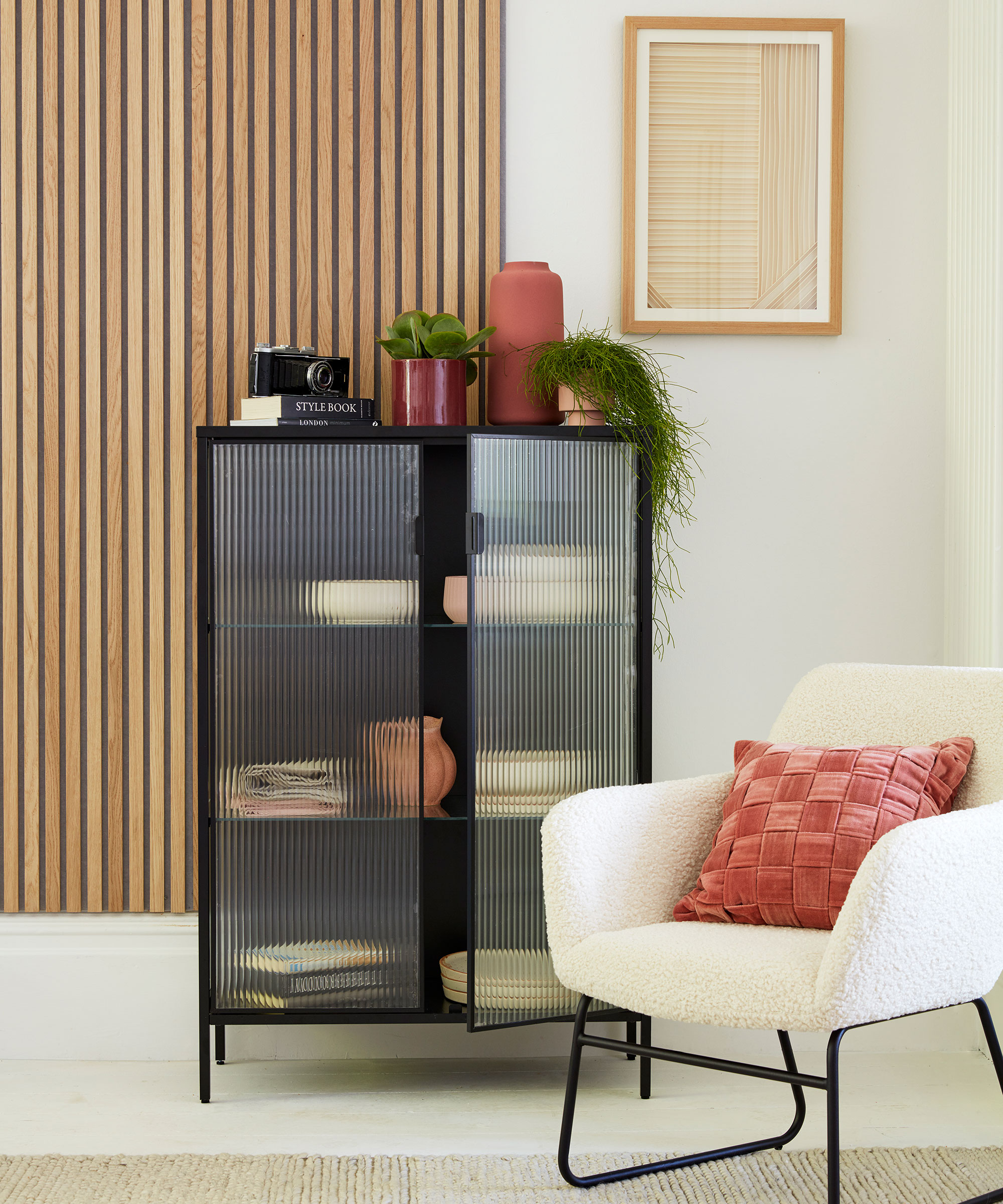 white room with armchair and cupboard