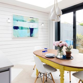 dining room with smart tv on wall and dining table with chairs