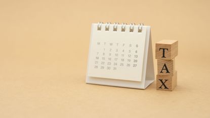 the word tax on blocks next to a blank calendar for estimated tax payments