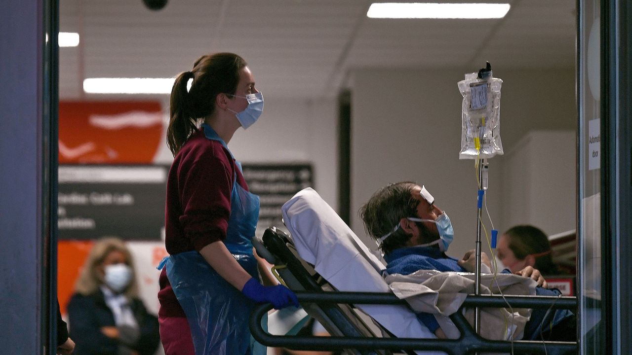 A Covid patient is wheeled into hospital