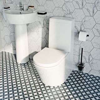 bathroom with toilet and washbasin and tiles flooring