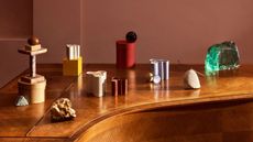 colourful candle holders arranged across a piano top