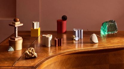 colourful candle holders arranged across a piano top