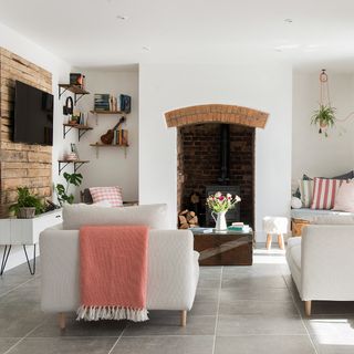 White living room with fireplace and grey tiled floors
